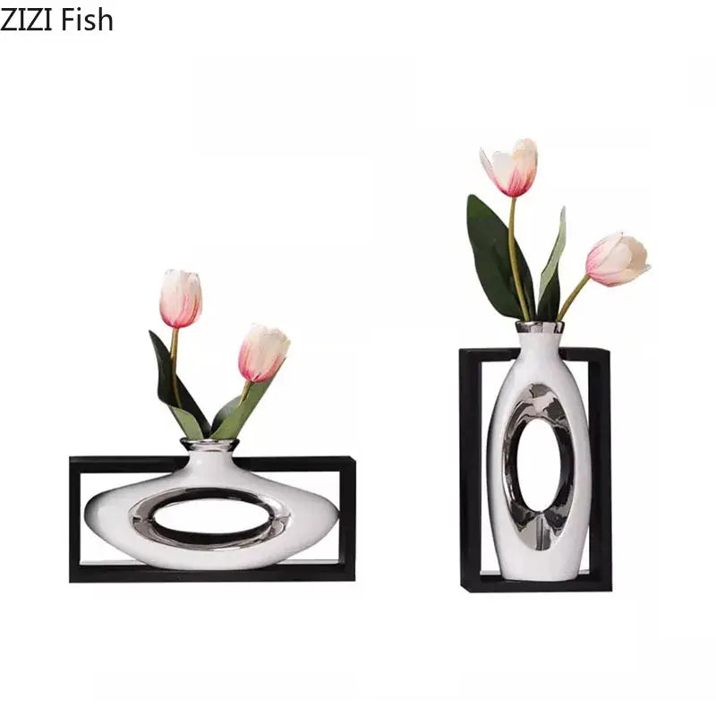 Modern metallic oval ceramic vase in white with sleek silver cutouts holding artificial pink tulips for decorbites elegant square desk decor