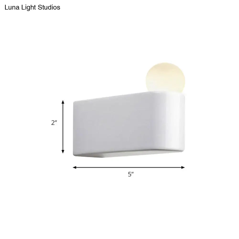 Modern milk glass wall lamp with white rectangular sconce and softly glowing spherical bulb for small medium spaces