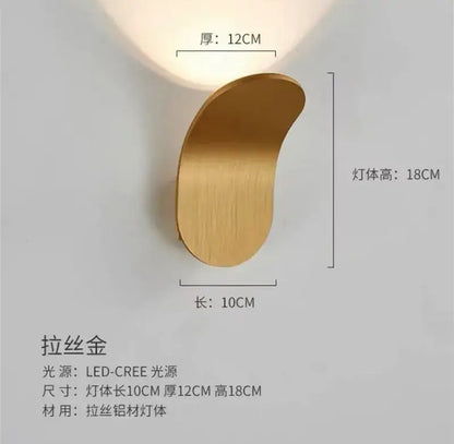 A sleek brushed gold modern minimalist adjustable led wall light with crescent design for bedroom use