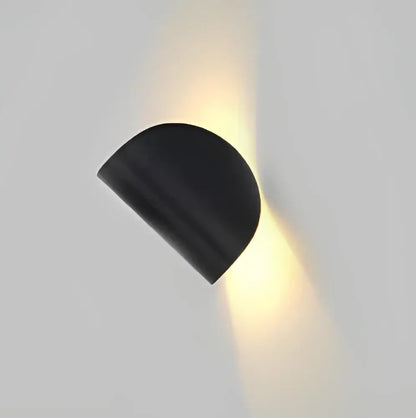 Modern minimalist black semi-circular wall lamp with matte finish emitting warm light decorbites art decor rotating