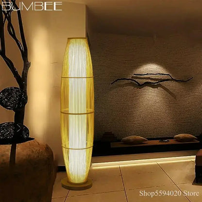Modern minimalist bamboo floor lamp with a warm golden glow and vertically slatted design ideal for living room decor