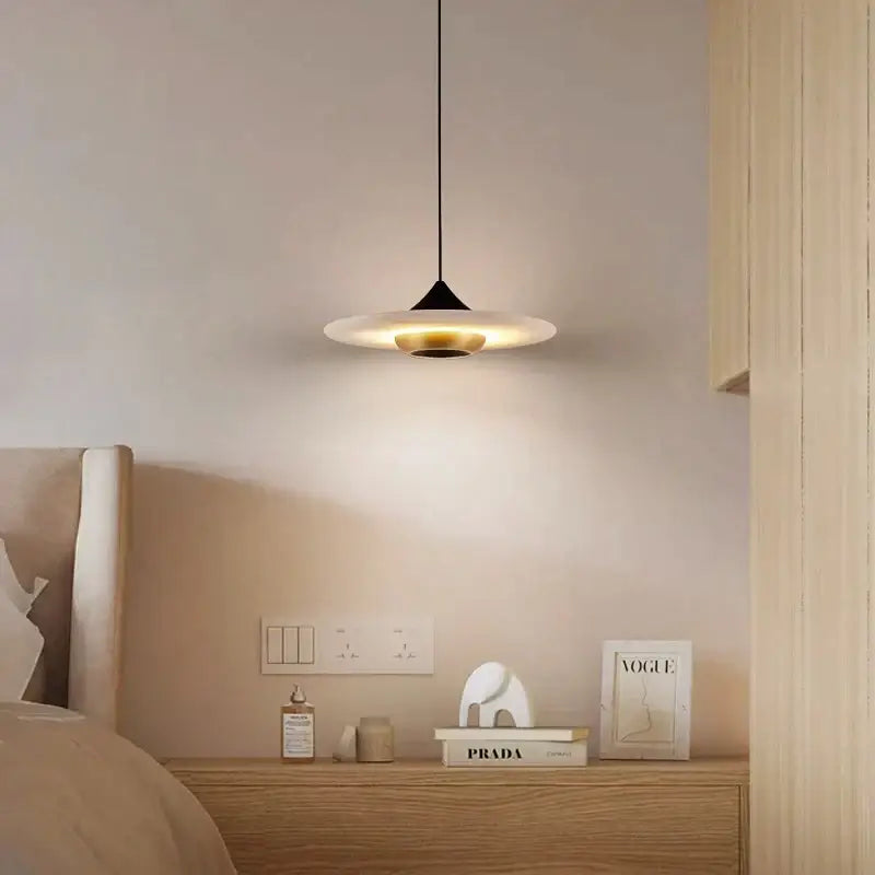 Modern minimalist black cloud stone pendant lamp with frosted glass disc providing warm ambient lighting by decorbites