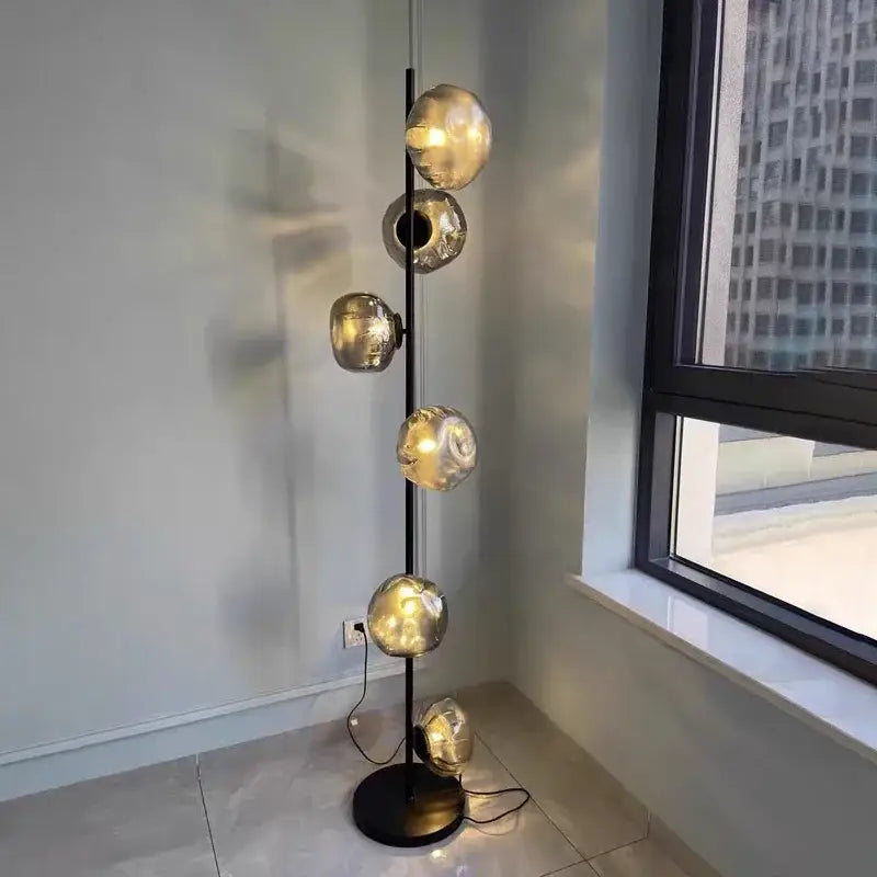 Modern minimalist black floor lamp with five spherical glass shade LED globes on a sleek pole for home decor