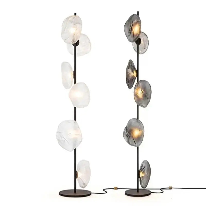 Two modern minimalist floor lamps with black metal poles and glass shade led orbs for stylish home decor