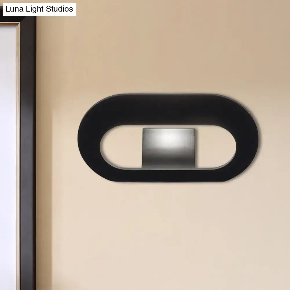 Modern minimalist black wall lamp with oval shade and central metallic panel for bedroom lighting maximum bulb wattage 60W