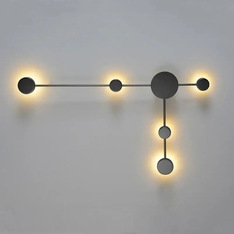 Modern minimalist black led wall lamp with five matte black circular fixtures in geometric t-shape for living space