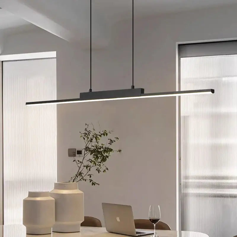 Modern minimalist black linear pendant light with sleek design and thin hanging cords for dining room lighting