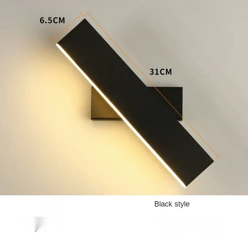 Modern minimalist black wall lamp with sleek rectangular design and warm edge light for bedroom bedside reading