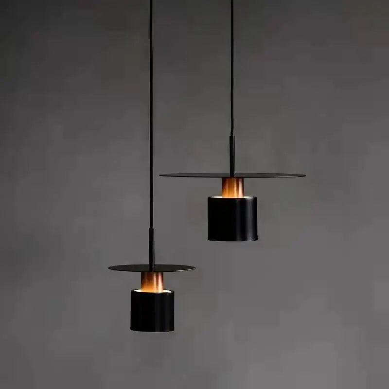 Modern minimalist black led pendant lights with warm glowing interiors for elegant kitchen lighting use