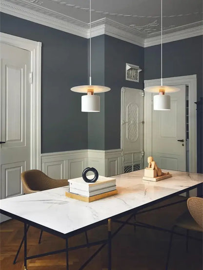 Two elegant led pendant lights with white cylindrical shades and copper fixtures for modern kitchen lighting