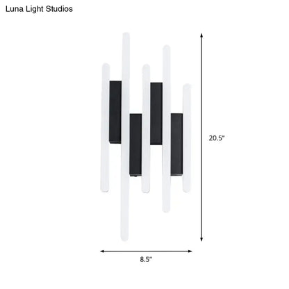 Modern minimalist black and white led wall sconce with a sleek rectangular design emitting warm white light for bedrooms