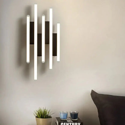 Modern minimalist black and white led wall sconce with five vertical bars alternating warm white light and matte black