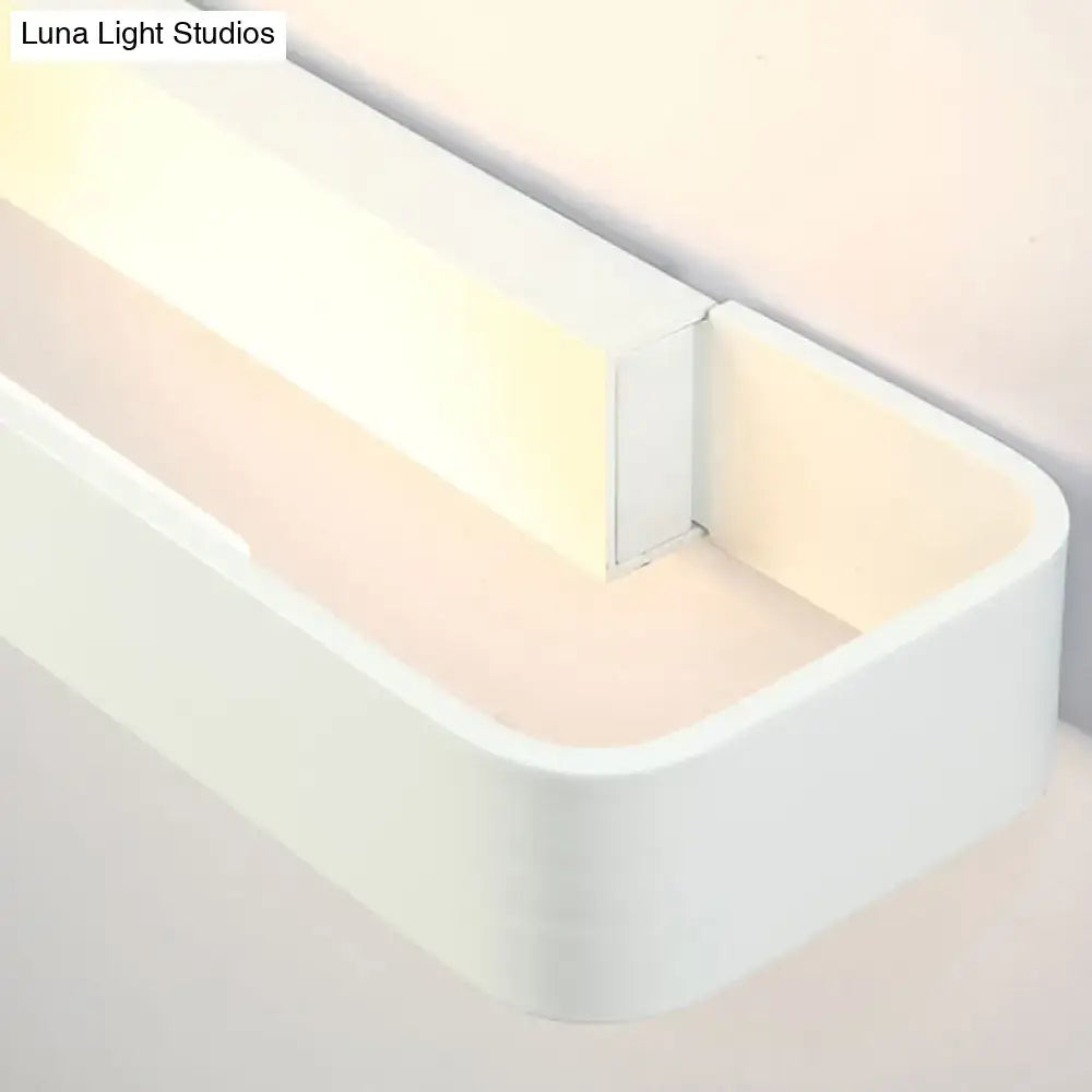 Modern minimalist white rectangular wall lamp with sleek design and soft diffused illumination for bedroom use
