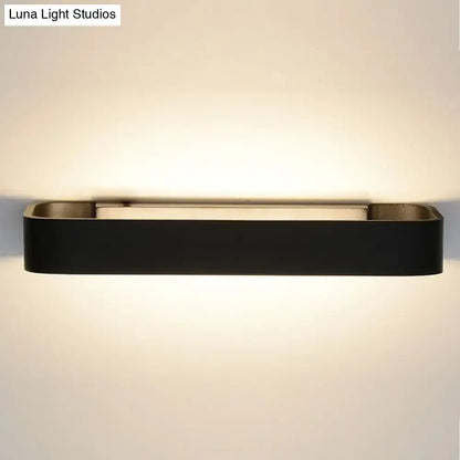Modern minimalist black rectangular wall lamp with metallic accents for bedroom lighting and wall mounting