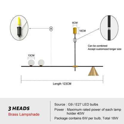 Modern minimalist brass and glass chandelier pendant light with three white spherical lampshades for dining room