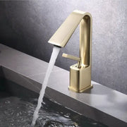 Modern minimalist brush gold basin faucet with sleek gold-toned design and single handle for flow control by Decorbites