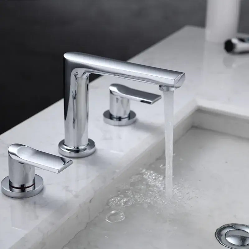 Modern chrome basin faucet with three handles and minimalist design complementing decorbites brush gold widespread style