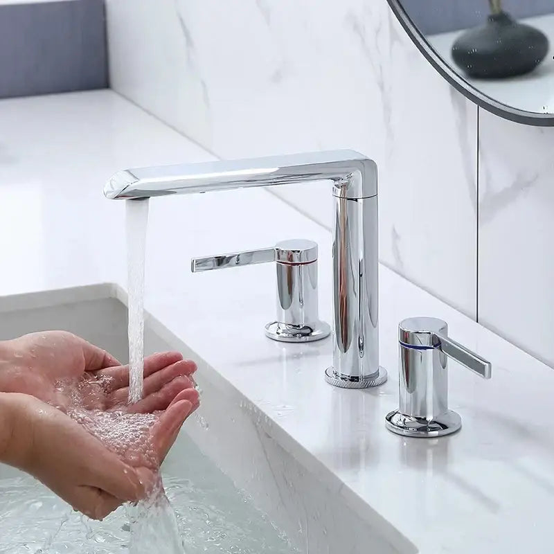 Modern minimalist chrome faucet with sleek rectangular spout and two cylindrical handles fitting gold brass widespread decorbites brushed gold style