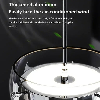 Modern minimalist chrome and glass dining pendant light with a thickened aluminum frame and transparent glass shade