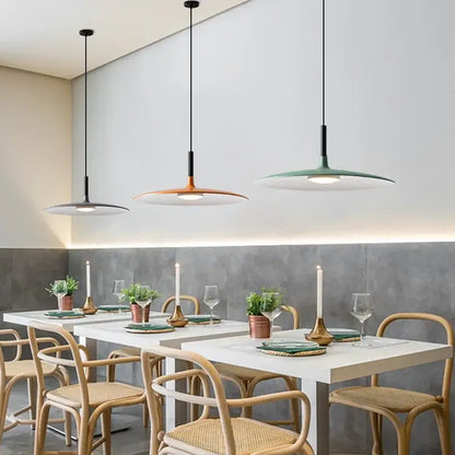 Three modern pendant lights with disc-shaped shades in matte gray copper and muted green for dining room decorbites colorful ufo pendant