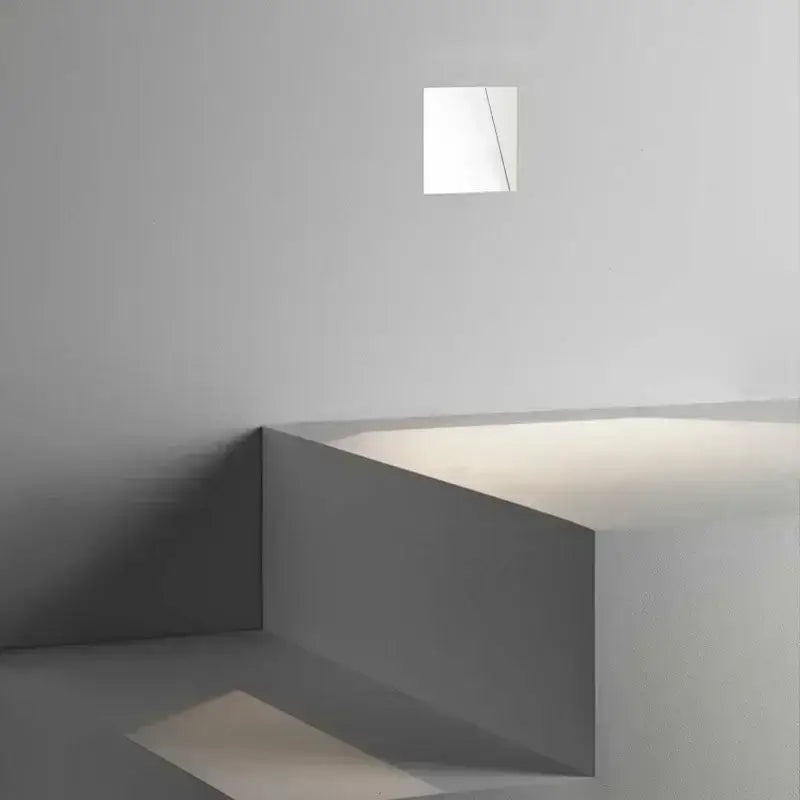 Modern minimalist concrete led underground lamp with a sleek white recessed wall light for garden stairway illumination