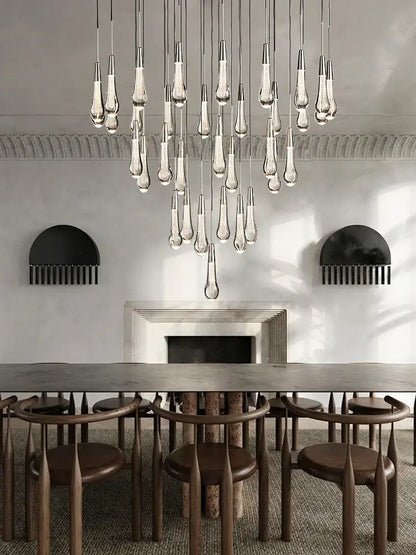 Modern minimalist ceiling chandelier featuring teardrop-shaped decorbites crystal water-drop glass with metallic fixtures