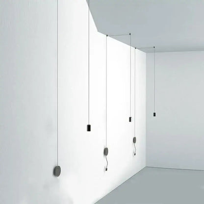 Minimalist black rope pendant lamp with cylindrical lights suspended from white ceiling for modern decorbites decor