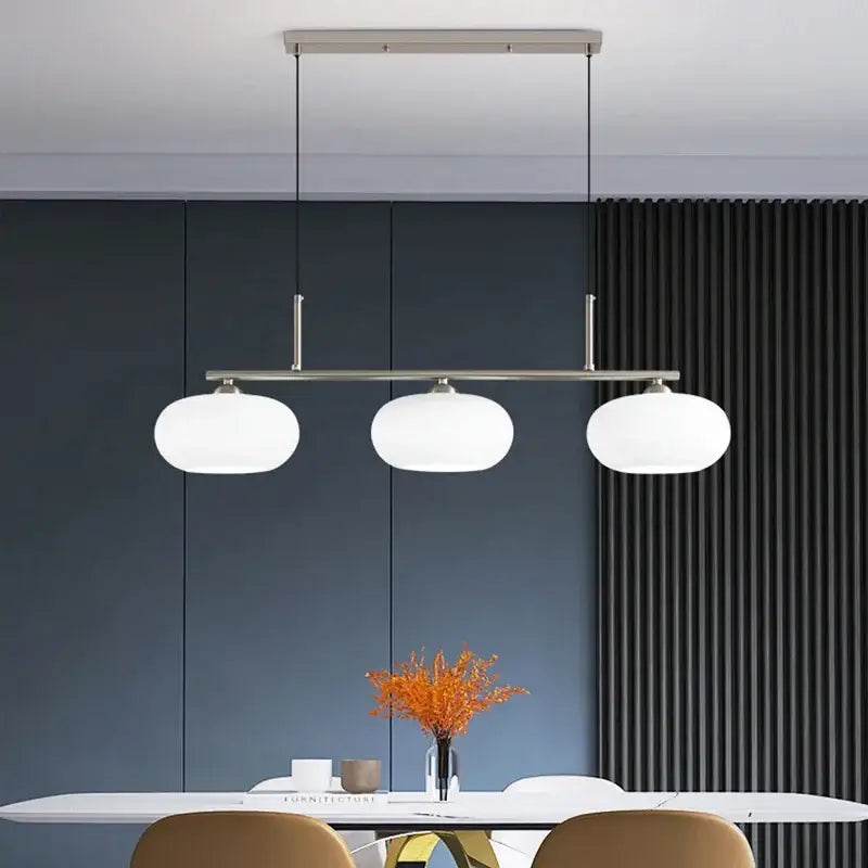 Modern minimalist decorbites glass chandelier with three frosted glass globes suspended by slender metal rods for living room