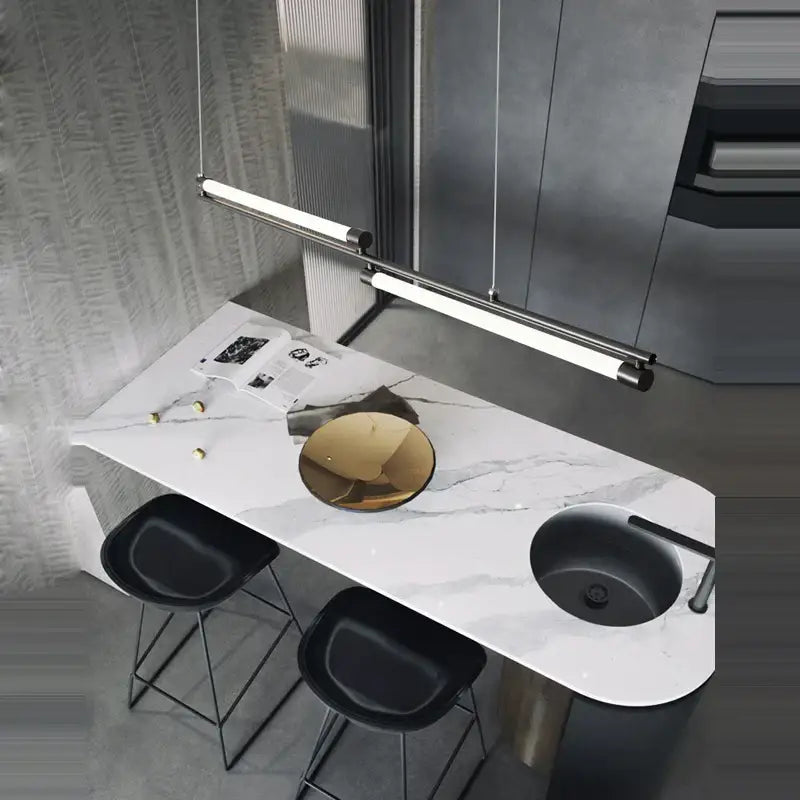 Modern minimalist dimmable led acryl chandelier above bar counter with white marble top black sink and gold bowl centerpiece