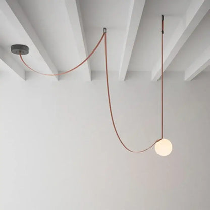 Modern minimalist pendant light with a frosted glass ball bulb, copper cable, and black metal decorbites glass ball fixtures