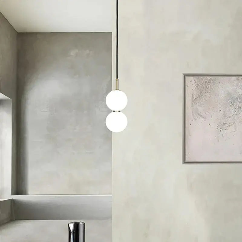Modern minimalist pendant light with two frosted glass ball spheres and brass decorbites glass ball hardware for living room