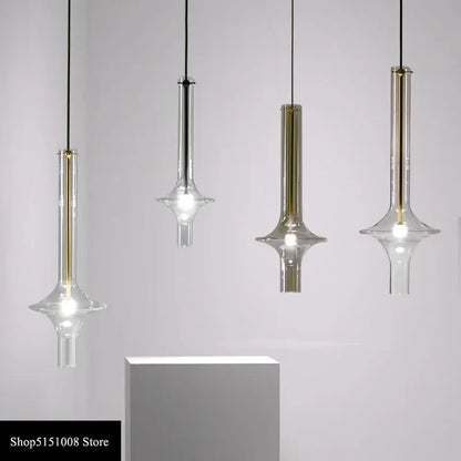 Four modern minimalist glass pendant lights with gold-toned accents and black cords for kitchen hanging lamps