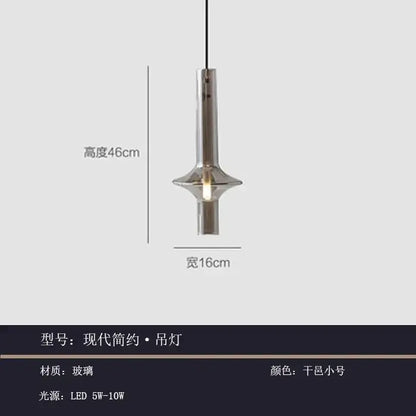 Modern minimalist glass pendant light with sleek cylindrical glass body and brushed metallic finish for kitchen use
