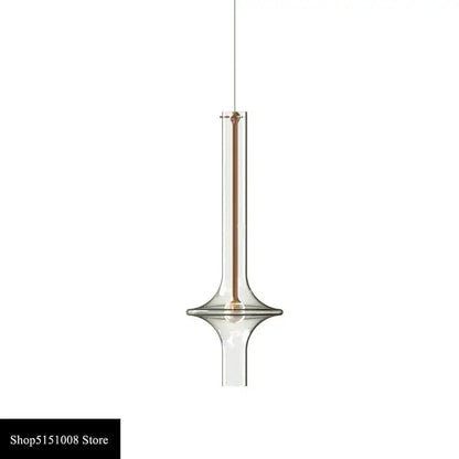 Modern minimalist glass pendant light with a slender transparent body and warm metallic accent for kitchen use