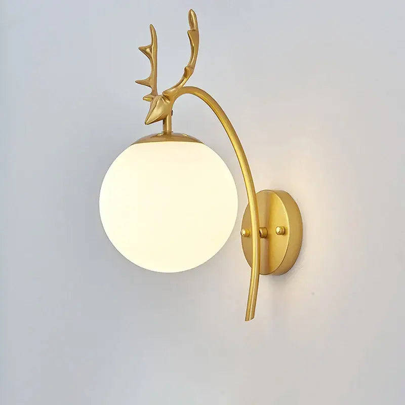Gold-toned deer-head wall lamp with a curved arm and frosted glass shade gold for modern minimalist bedroom decor