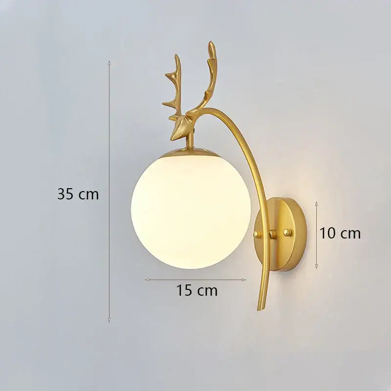 Gold-toned deer-head wall lamp with frosted glass shade gold designed as a modern minimalist bedroom fixture