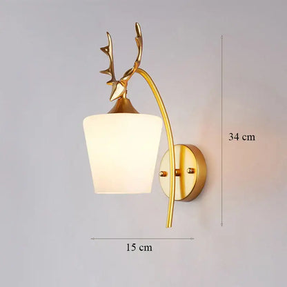Modern minimalist wall lamp with gold-toned deer antler design and frosted white glass shade for bedroom use
