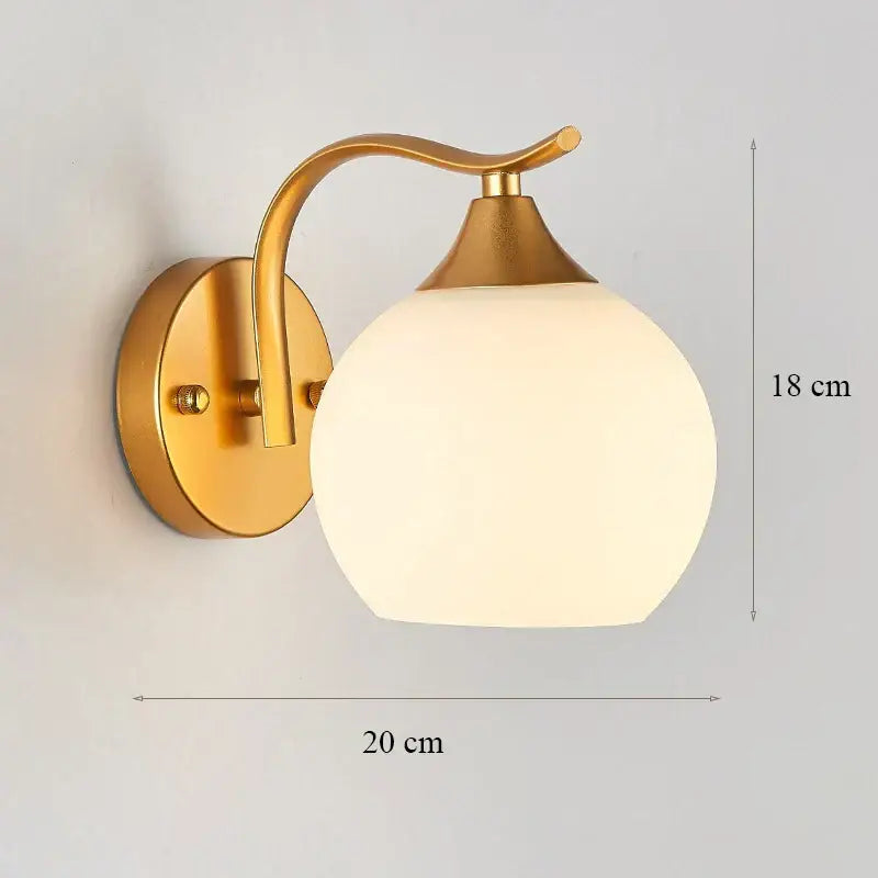 Modern minimalist gold wall lamp with frosted glass shade and curved arm for bedroom lighting