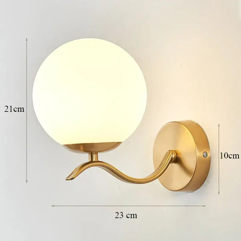 Modern minimalist gold wall lamp with glass shade and frosted globe on curved arm for bedroom lighting