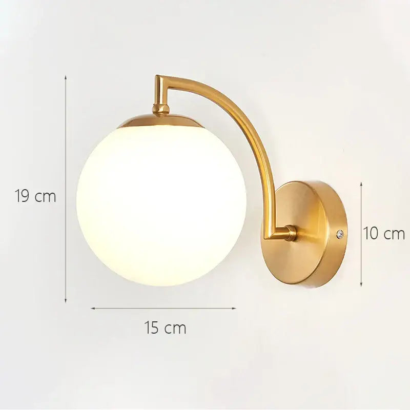 Modern minimalist wall lamp with a gold-toned metal arm and frosted glass shade gold for bedroom lighting