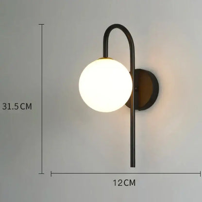 Modern minimalist black metal wall lamp with frosted glass globe and glass gold led accents for bedroom decorbites decor