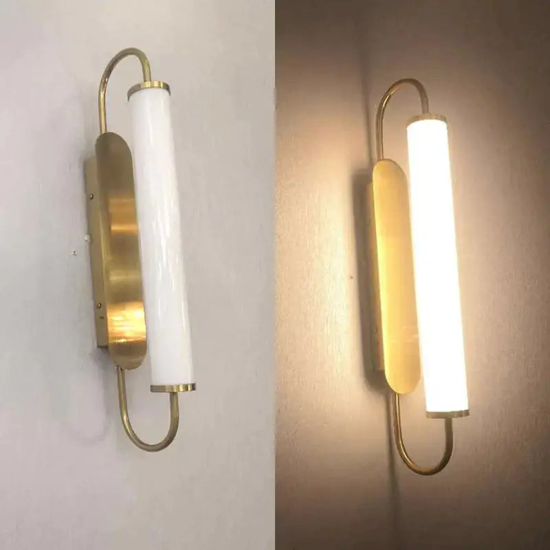Modern minimalist gold led wall lamp with frosted glass cylinder and curved brass arms for bedroom lighting