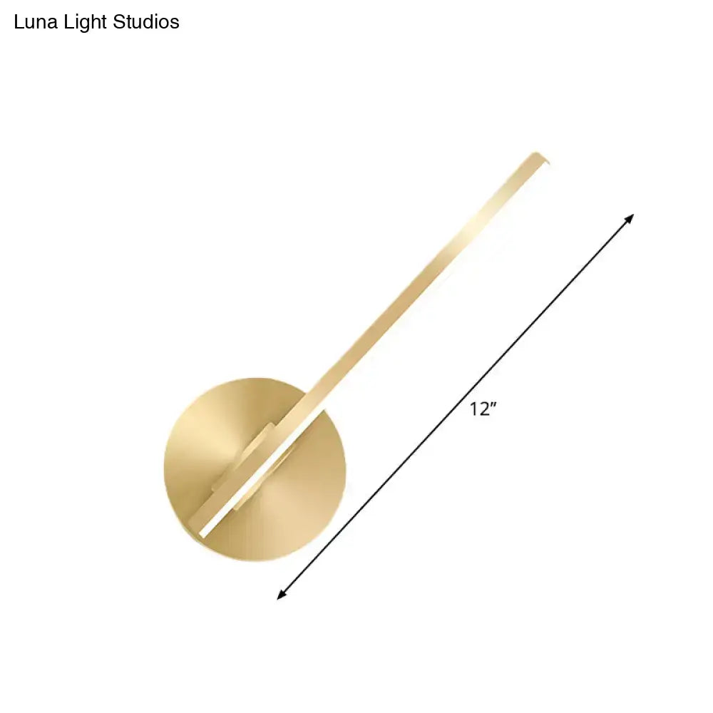 Modern minimalist gold tube stick wall sconce with a gold-toned circular base and slender angular arm for bedroom lighting