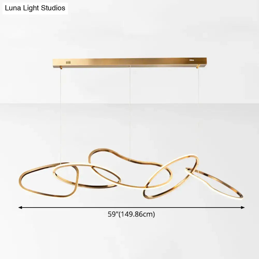 Modern minimalist golden hanging light with interconnected flowing rings suspended from a sleek rectangular bar