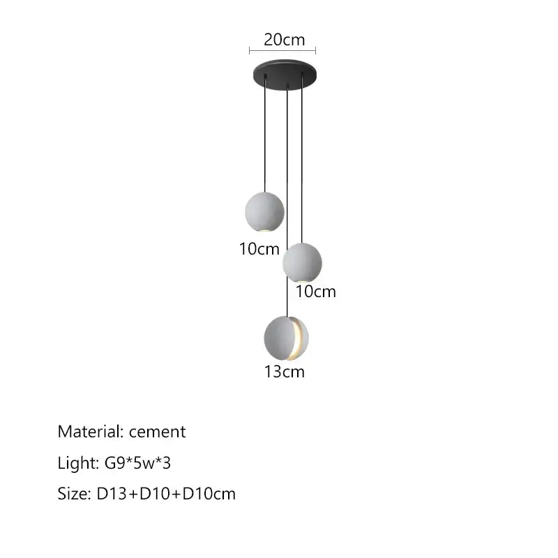 Modern minimalist gray and gold pendant light featuring matte cement spheres and a sleek black mount for dining room decorbites cement planet chandelier