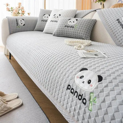 Gray quilted sofa cover with embroidered panda faces and bamboo motifs for modern minimalist light green living rooms