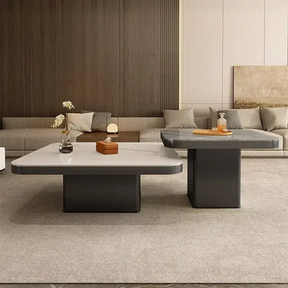 Modern minimalist coffee table set with a white marble top and dark gray base for elegant living room decor