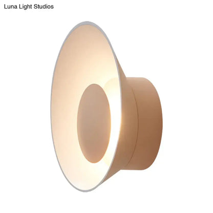 Modern minimalist beige wall lamp with sleek circular design and soft ambient LED lighting for living room use