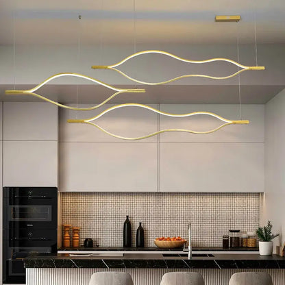 Modern minimalist white and bronze decorbites lip shaped chandelier with gold wave pendant lights above kitchen island