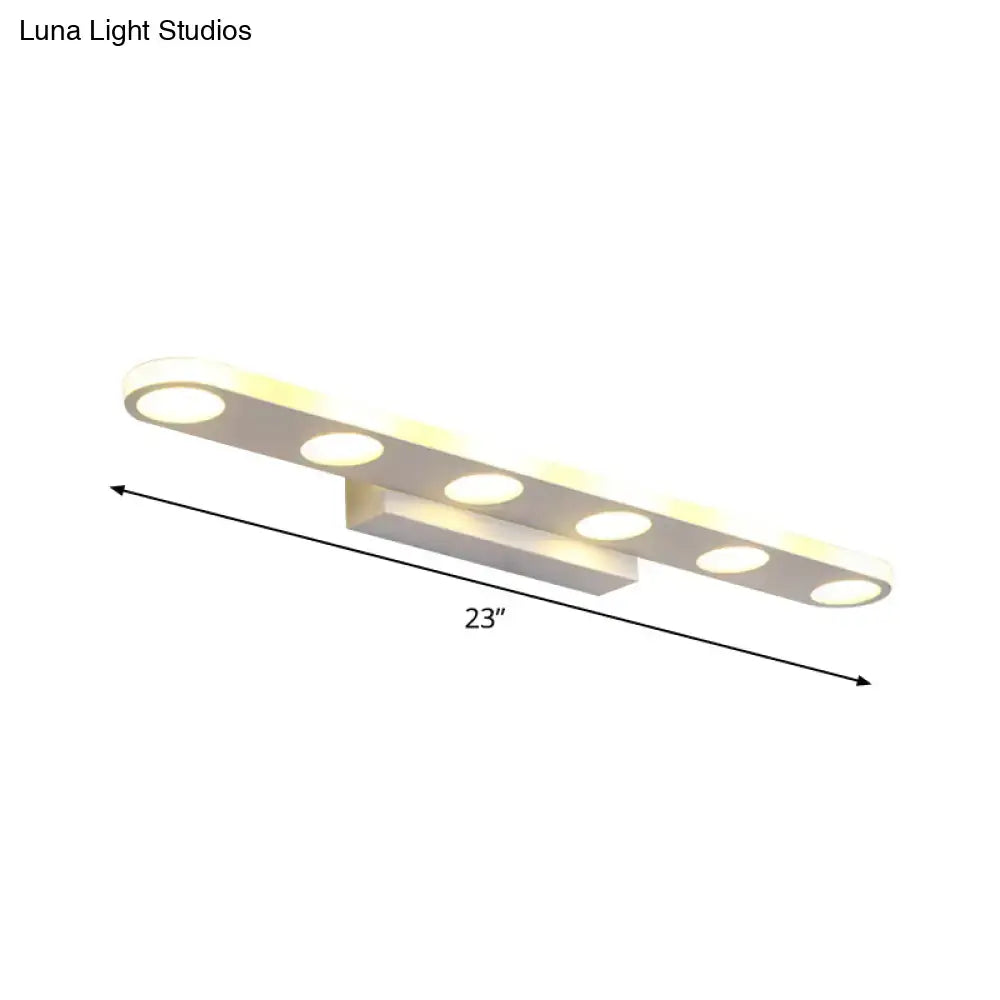 A modern minimalist 23-inch vanity light with five warm acrylic shade bulbs in white finish for bathroom use
